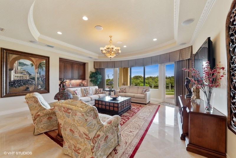 16904 Passage South Jupiter, FL 33477 - Photo 2 of 22 a living room with furniture a flat screen tv and a large window