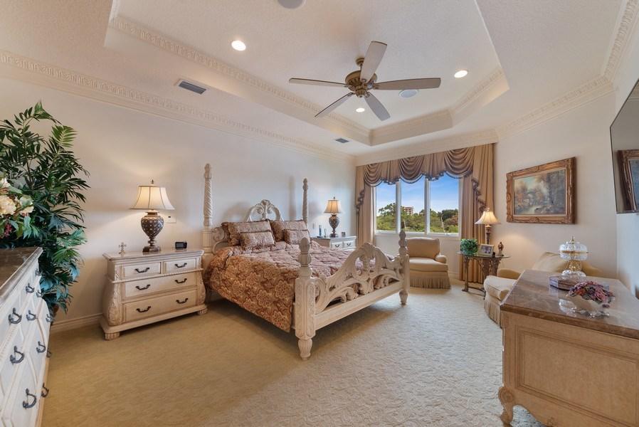 16904 Passage South Jupiter, FL 33477 - Photo 12 of 22 a bedroom with a bed and a chandelier