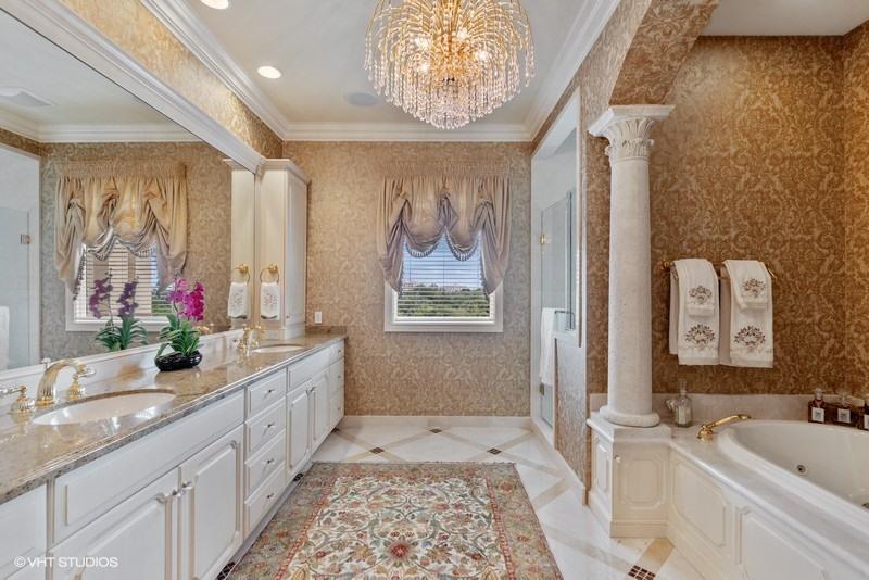 16904 Passage South Jupiter, FL 33477 - Photo 13 of 22 a bathroom with a granite countertop sink a large mirror and a shower