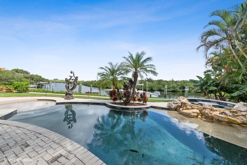 16904 Passage South Jupiter, FL 33477 - Photo 17 of 22 a view of a swimming pool and lounge chair