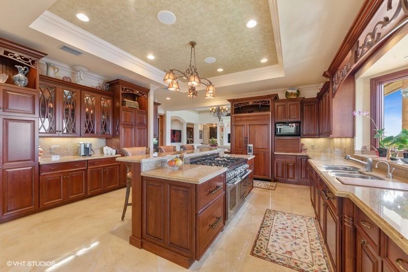 16904 Passage South Jupiter, FL 33477 - Photo 6 of 22 a large kitchen with a counter space a sink appliances and cabinets