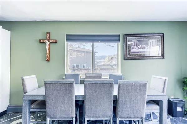 a dining room with furniture and window