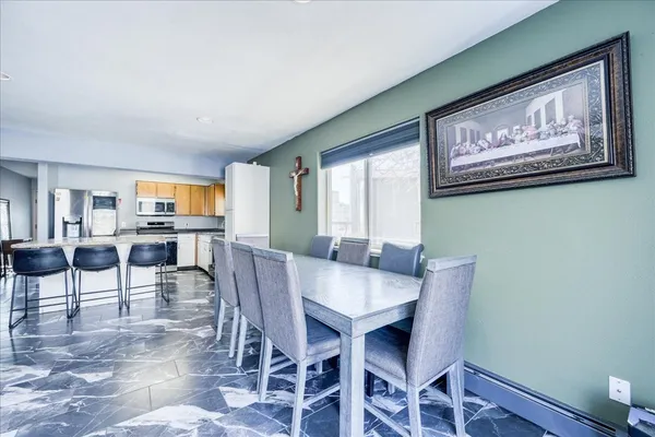 a view of a dining room with furniture and wooden floor