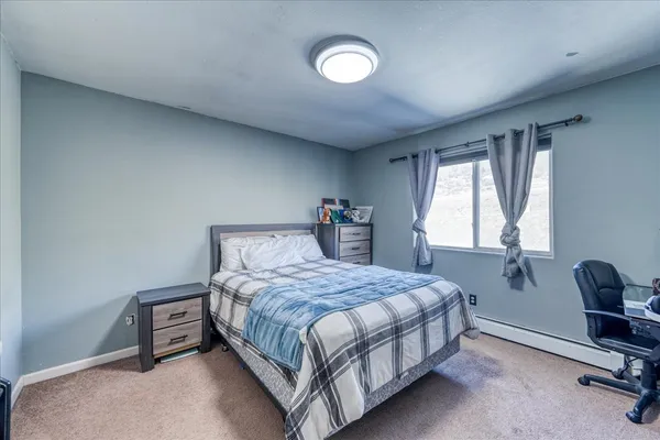 a bedroom with a bed and a lounge chair