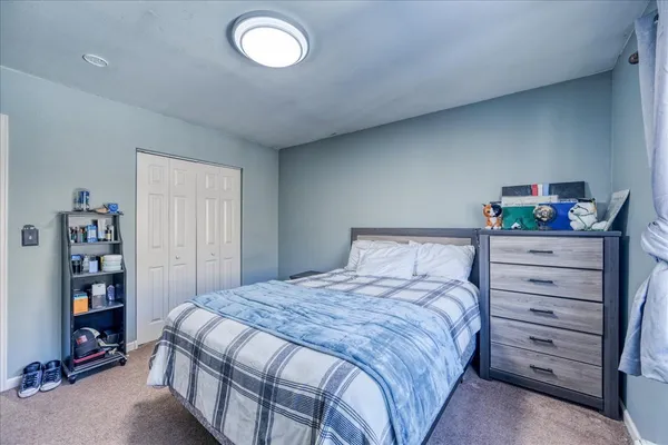 a bedroom with a bed and a closet