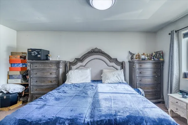 a bedroom with a bed and furniture