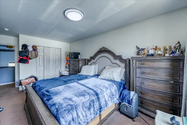 a bedroom with a bed and closet