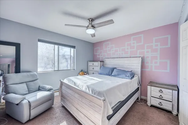 a bedroom with a bed and a couch