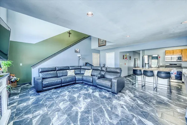 a living room with furniture and a potted plant