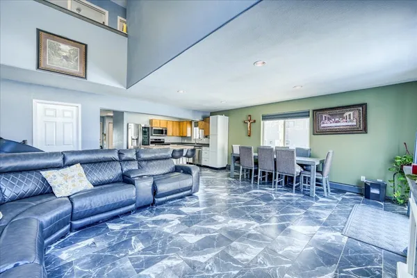 a living room with furniture and a dining table