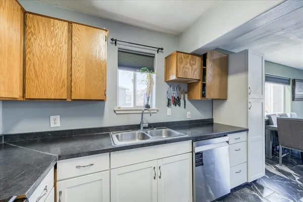 a kitchen with stainless steel appliances granite countertop a sink and a cabinets