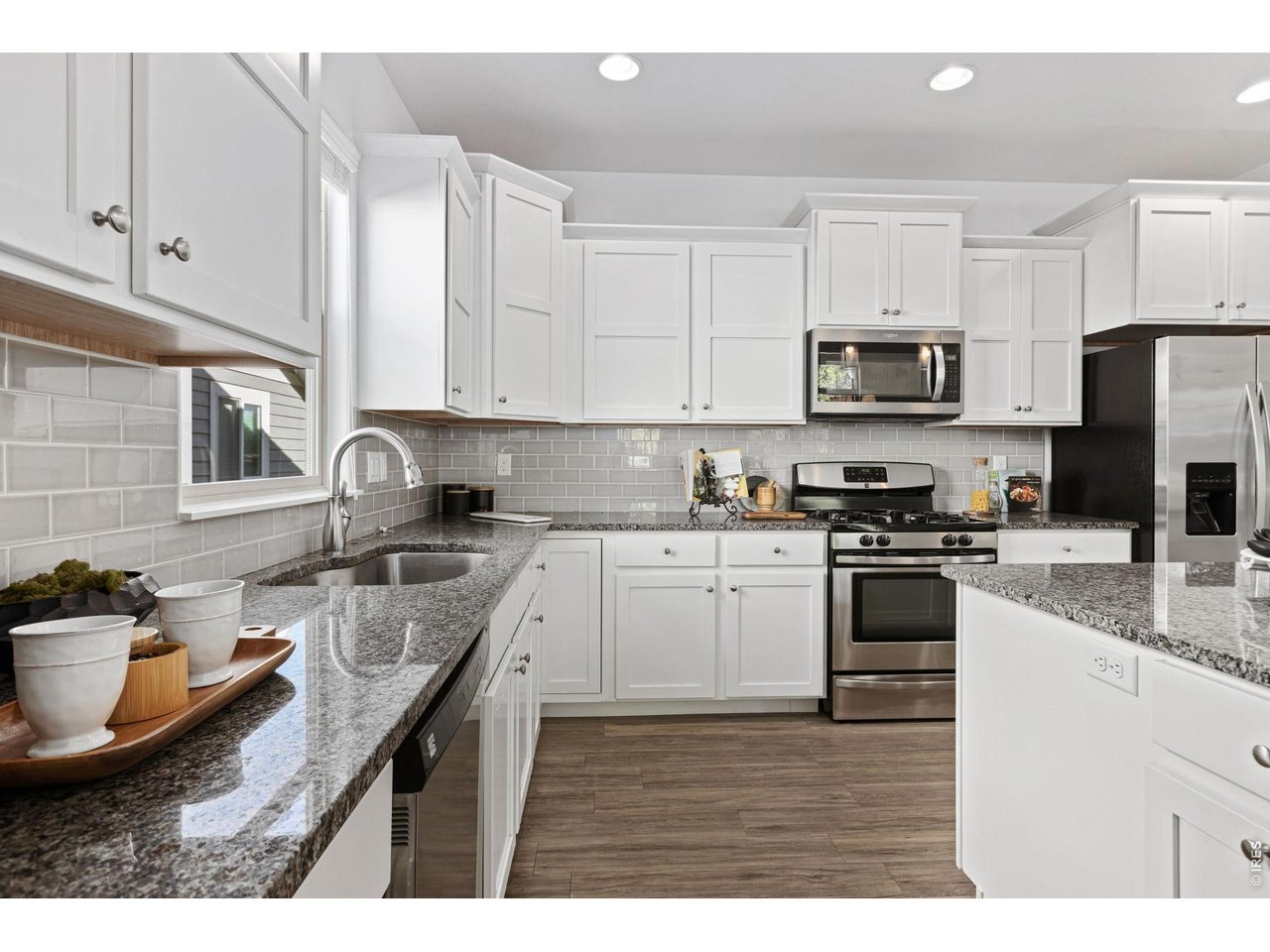 6511 19th Street Greeley, CO 80634 - Photo 8 of 26 Granite Counters and Stainless Steel Appliances as well as Generous Cabinet Space and a Pantry