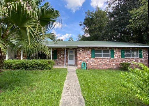 930 Northwest 36th Avenue Gainesville, FL 32609 - Photo 1 of 9 a front view of house with yard and green space