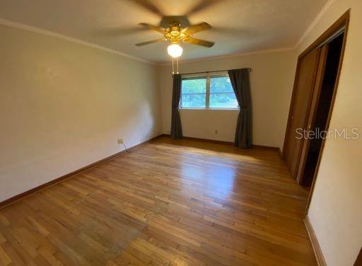930 Northwest 36th Avenue Gainesville, FL 32609 - Photo 6 of 9 wooden floor in an empty room with a window