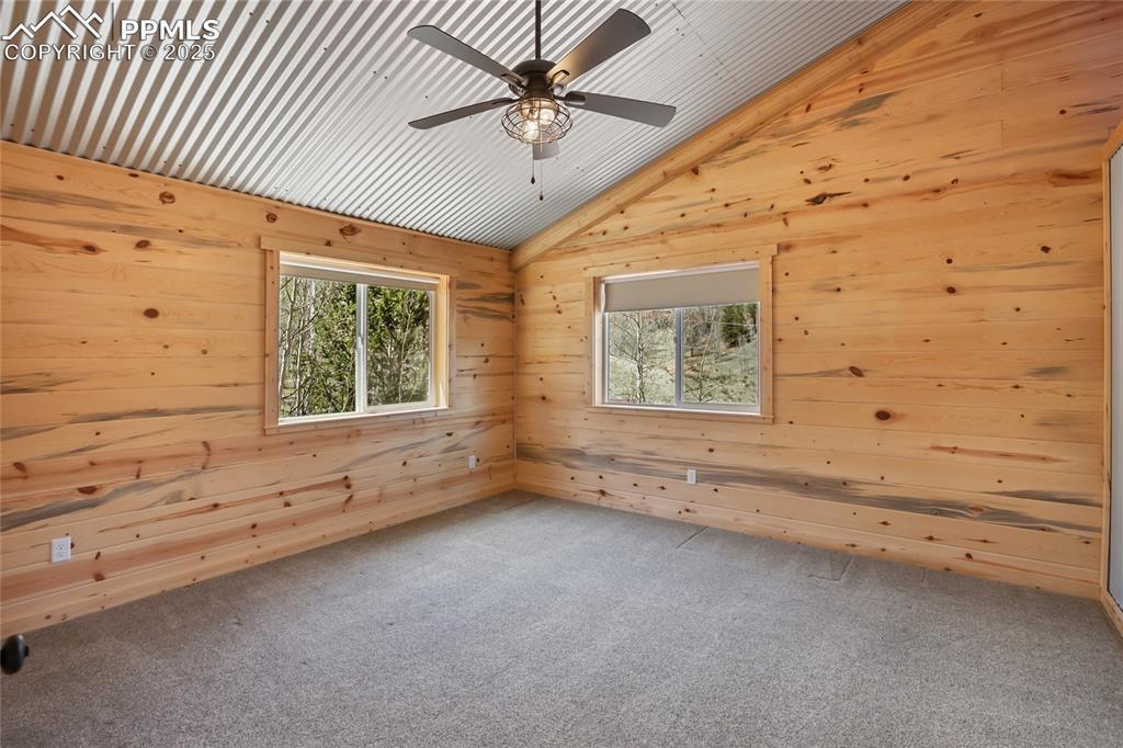 621 Yorktown Road Cripple Creek, CO 80813 - Photo 17 of 29 Bedroom #3 with pine paneling, carpet and ceiling fan. Lots of natural light!