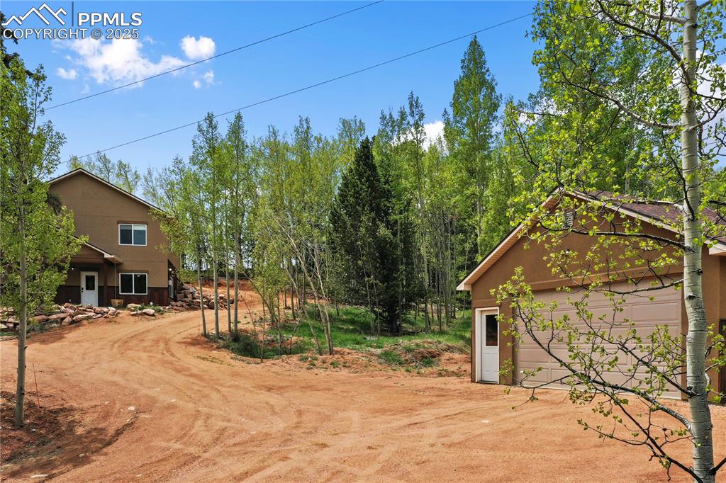 621 Yorktown Road Cripple Creek, CO 80813 - Photo 4 of 29 View of yard with a garage, an outdoor structure, and driveway