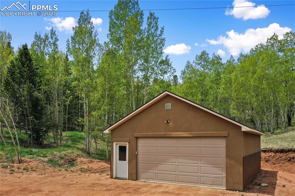 621 Yorktown Road Cripple Creek, CO 80813 - Photo 5 of 29 Detached garage featuring a forest view