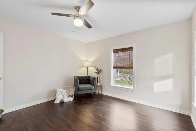 a view of livingroom with furniture wooden floor ceiling fan and window