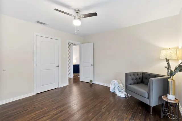a living room with furniture and a ceiling fan