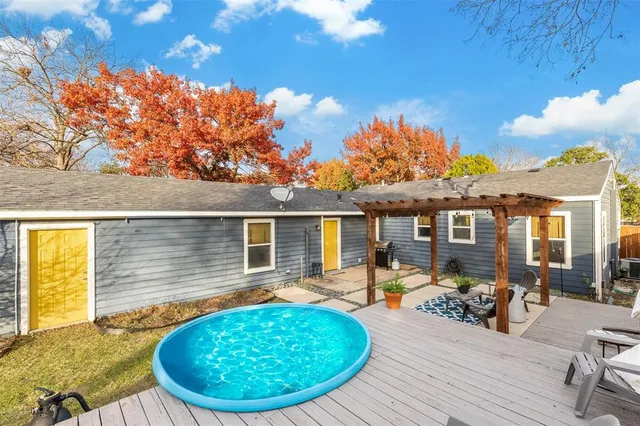 a view of a house with backyard porch and sitting area