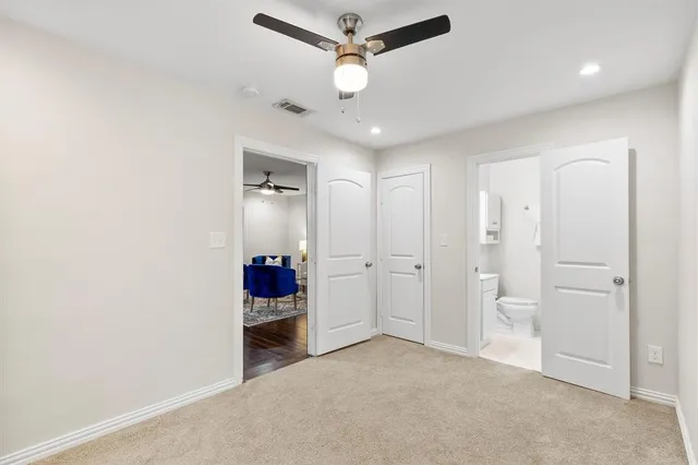 an empty room with closet and ceiling fan