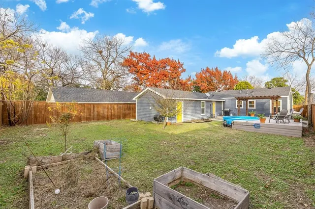 a bathroom with a granite countertop sink a mirror and shower