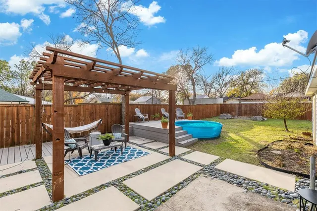 a view of a patio with couches table and chairs and potted plants