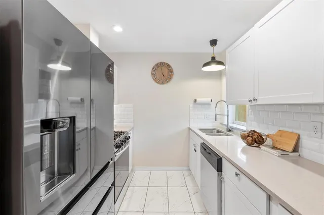 a kitchen with a sink and refrigerator