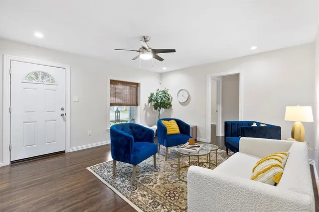 a living room with furniture and wooden floor