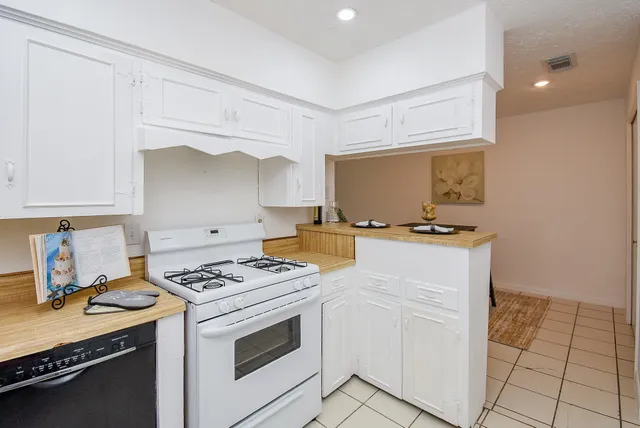 a kitchen with cabinets and appliances