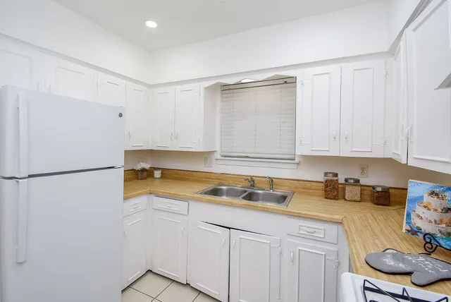 a kitchen with a sink cabinets and appliances