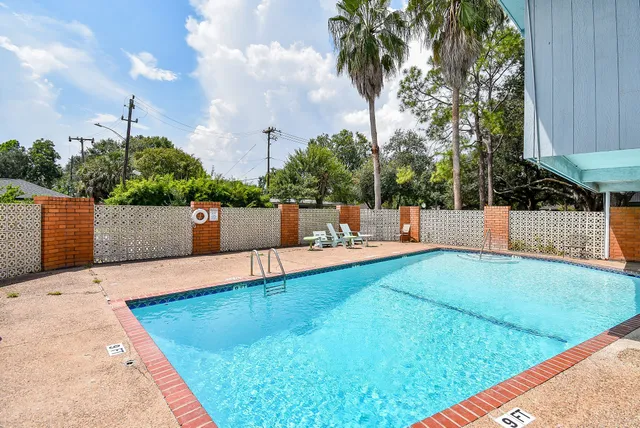 a view of a backyard with swimming pool