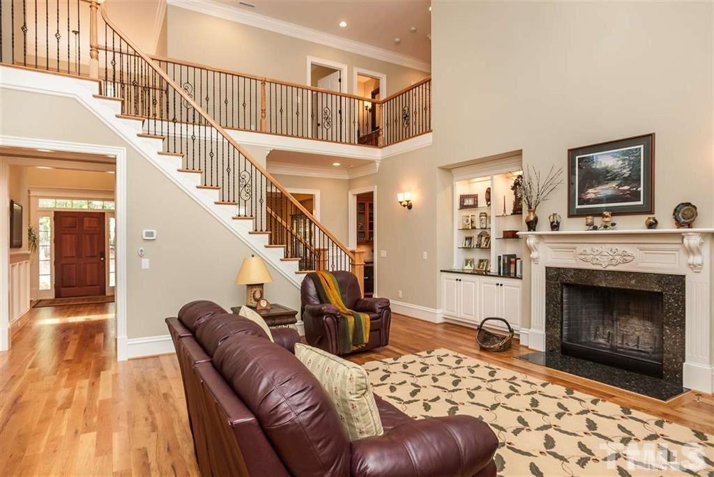 5515 Strathmore Drive Raleigh, NC 27613 - Photo 5 of 25 a living room with furniture and a fireplace