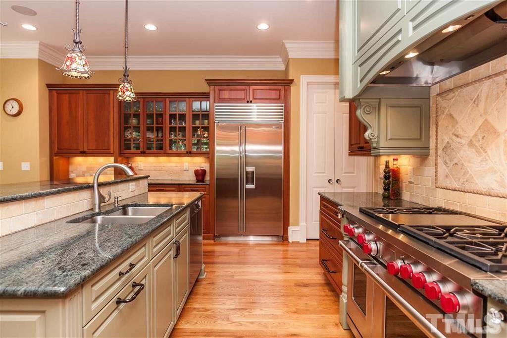 5515 Strathmore Drive Raleigh, NC 27613 - Photo 8 of 25 a kitchen with stainless steel appliances granite countertop a sink stove and refrigerator