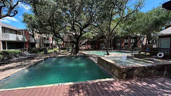 a swimming pool with outdoor seating and yard
