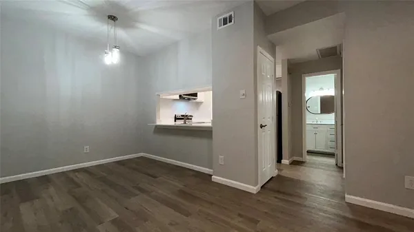 a view of a room with wooden floor