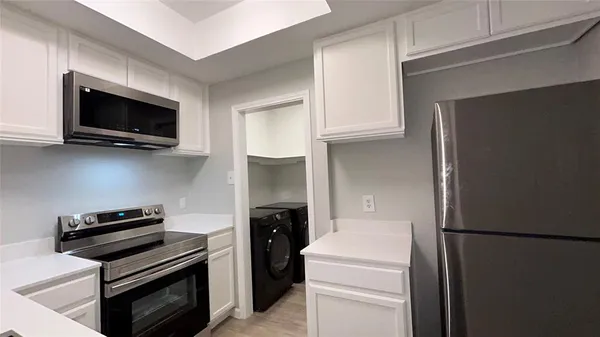 a kitchen with a refrigerator stove and microwave