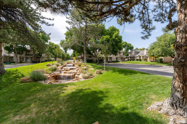 888 East 6895 South Midvale, UT 84047 - Photo 47 of 54 Beautifully maintained common area featuring lush lawns, mature trees, and a peaceful setting ideal for relaxing or enjoying the outdoors.