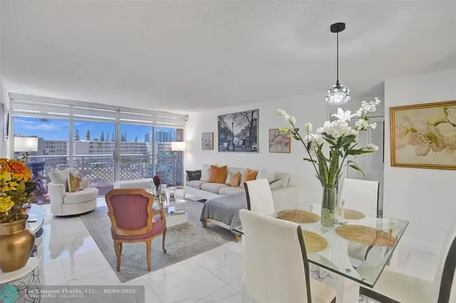 a living room filled with furniture and a chandelier