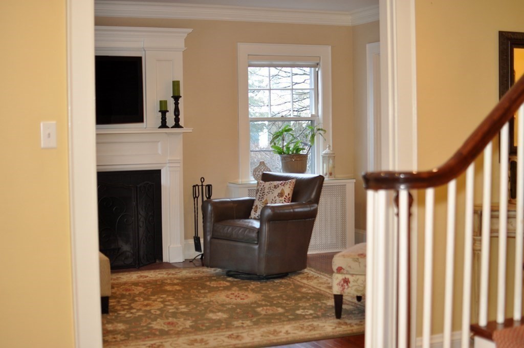 75 Winchester Road Arlington, MA 02474 - Photo 11 of 42 a living room with furniture and a fireplace