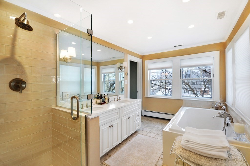 75 Winchester Road Arlington, MA 02474 - Photo 30 of 42 a bathroom with a double vanity sink mirror and a bathtub