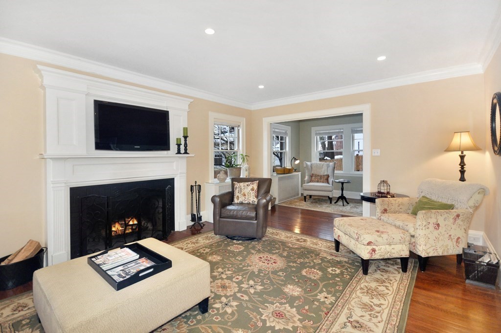75 Winchester Road Arlington, MA 02474 - Photo 3 of 42 a living room with furniture a flat screen tv and a fireplace