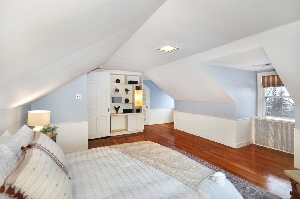 75 Winchester Road Arlington, MA 02474 - Photo 36 of 42 a bedroom with a large bed and a chandelier