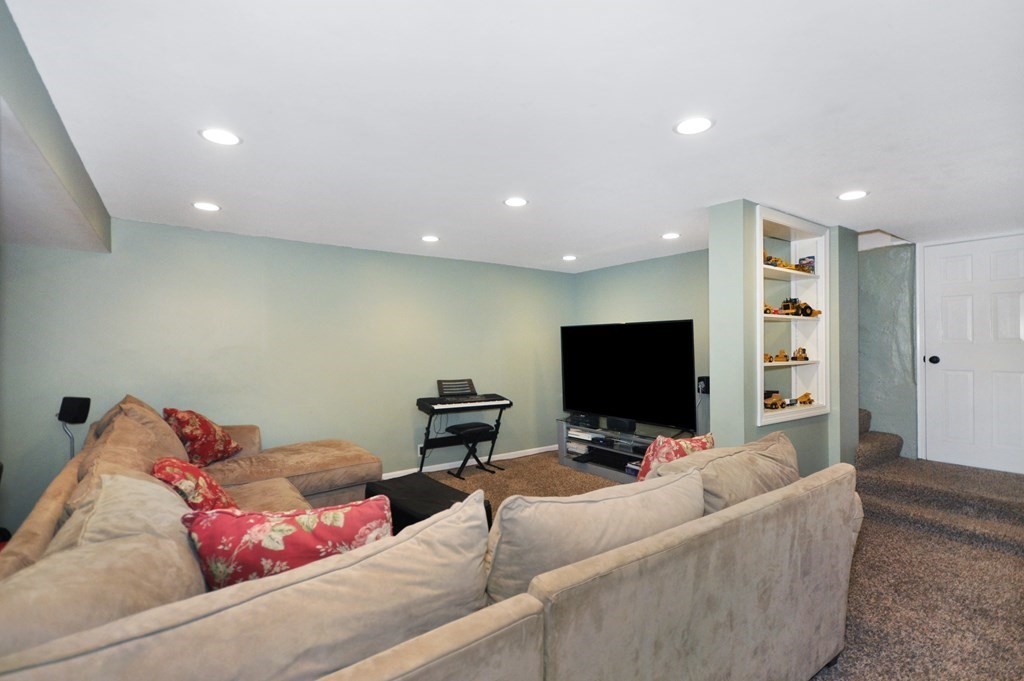 75 Winchester Road Arlington, MA 02474 - Photo 39 of 42 a living room with furniture and a flat screen tv