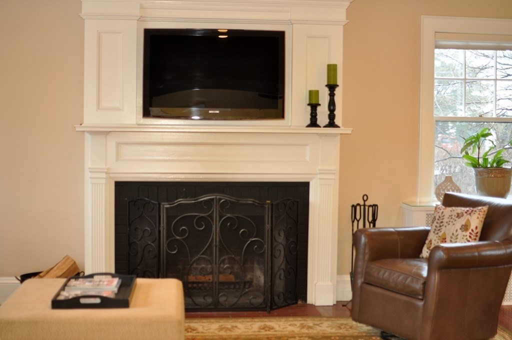 75 Winchester Road Arlington, MA 02474 - Photo 6 of 42 a living room with furniture and a fireplace