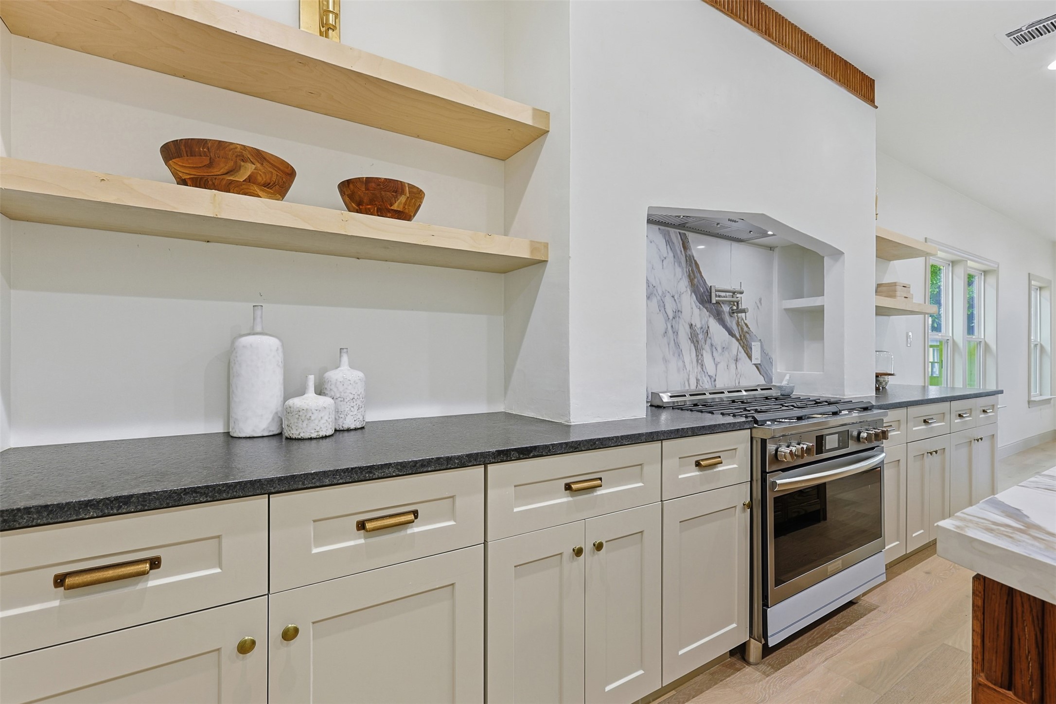 1202 Aurora Street Houston, TX 77009 - Photo 15 of 37 a kitchen with white cabinets and white appliances