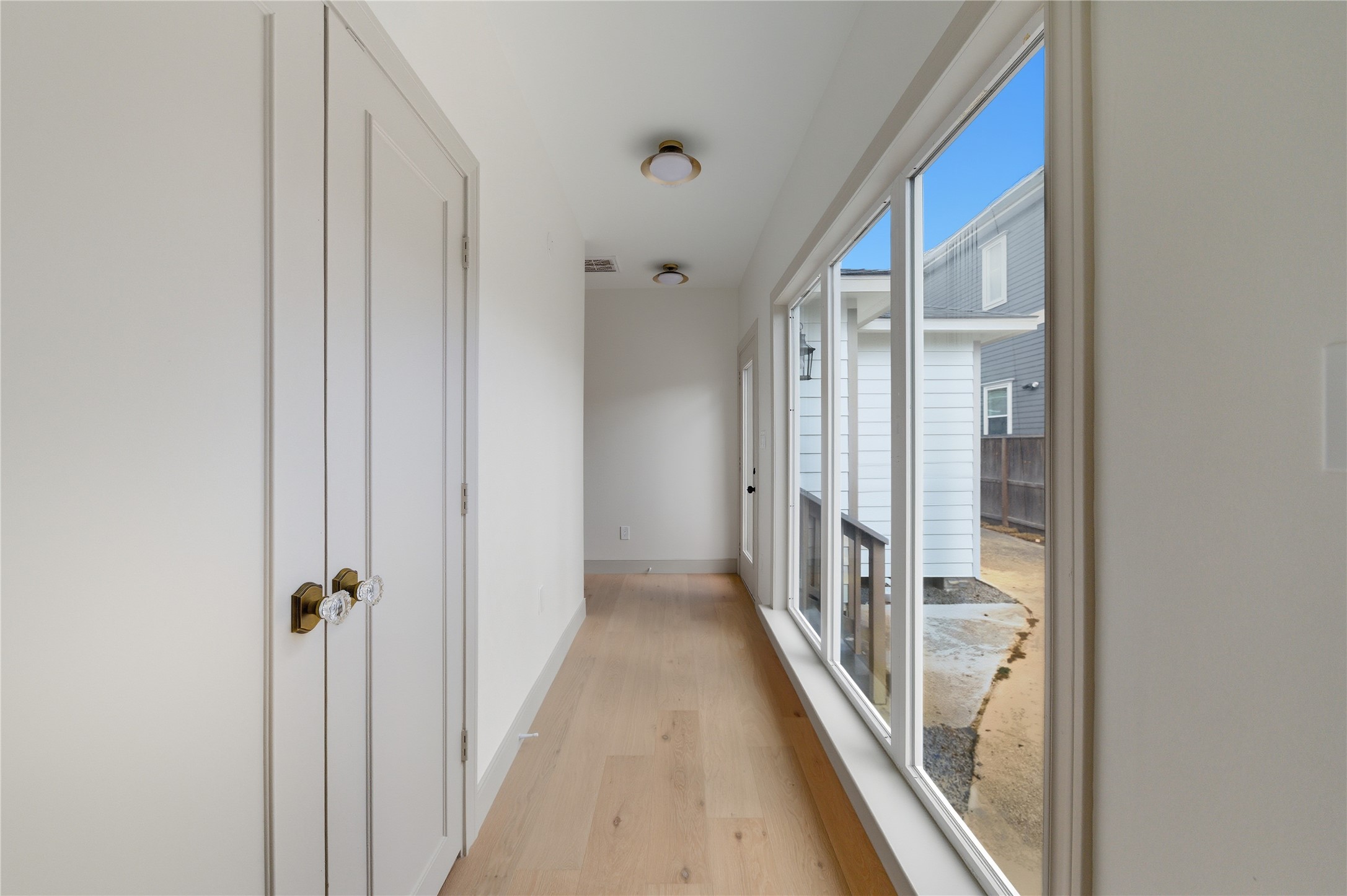1202 Aurora Street Houston, TX 77009 - Photo 24 of 37 a view of a hallway with wooden floor and staircase