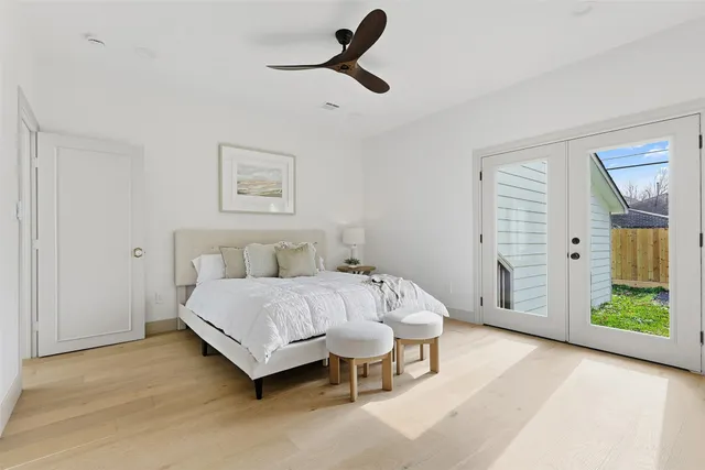 a spacious bedroom with a bed and a chandelier