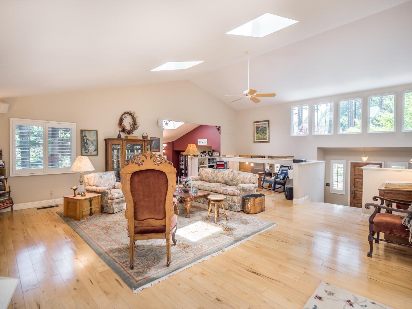 12445 Alba Road Ben Lomond, CA 95005 - Photo 12 of 37 a living room with furniture a fireplace and a large window