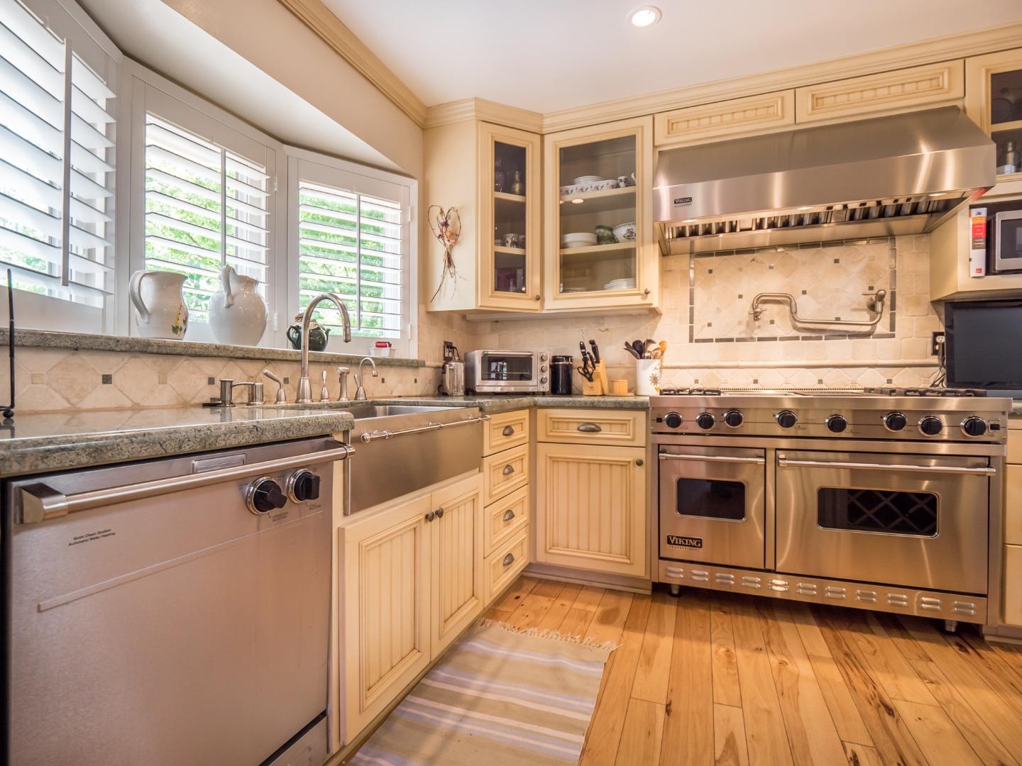 12445 Alba Road Ben Lomond, CA 95005 - Photo 25 of 37 a white kitchen with granite countertop a stove top oven sink and cabinets